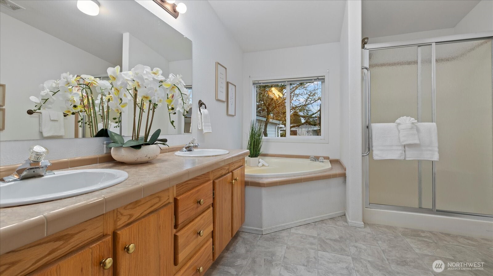 23825 15th Avenue Southeast, Unit 1 Bothell, WA 98021 - Photo 19 of 25 a bathroom with a double vanity sink a mirror and a bathtub