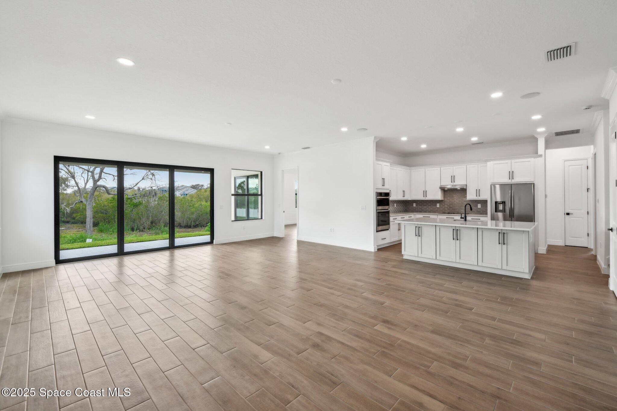 1405 Windchime Lane Melbourne, FL 32935 - Photo 12 of 48 a view of kitchen with furniture and wooden floor