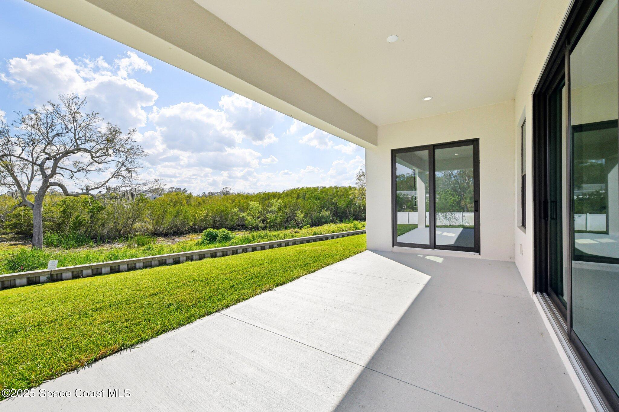 1405 Windchime Lane Melbourne, FL 32935 - Photo 15 of 48 a view of a porch with a yard