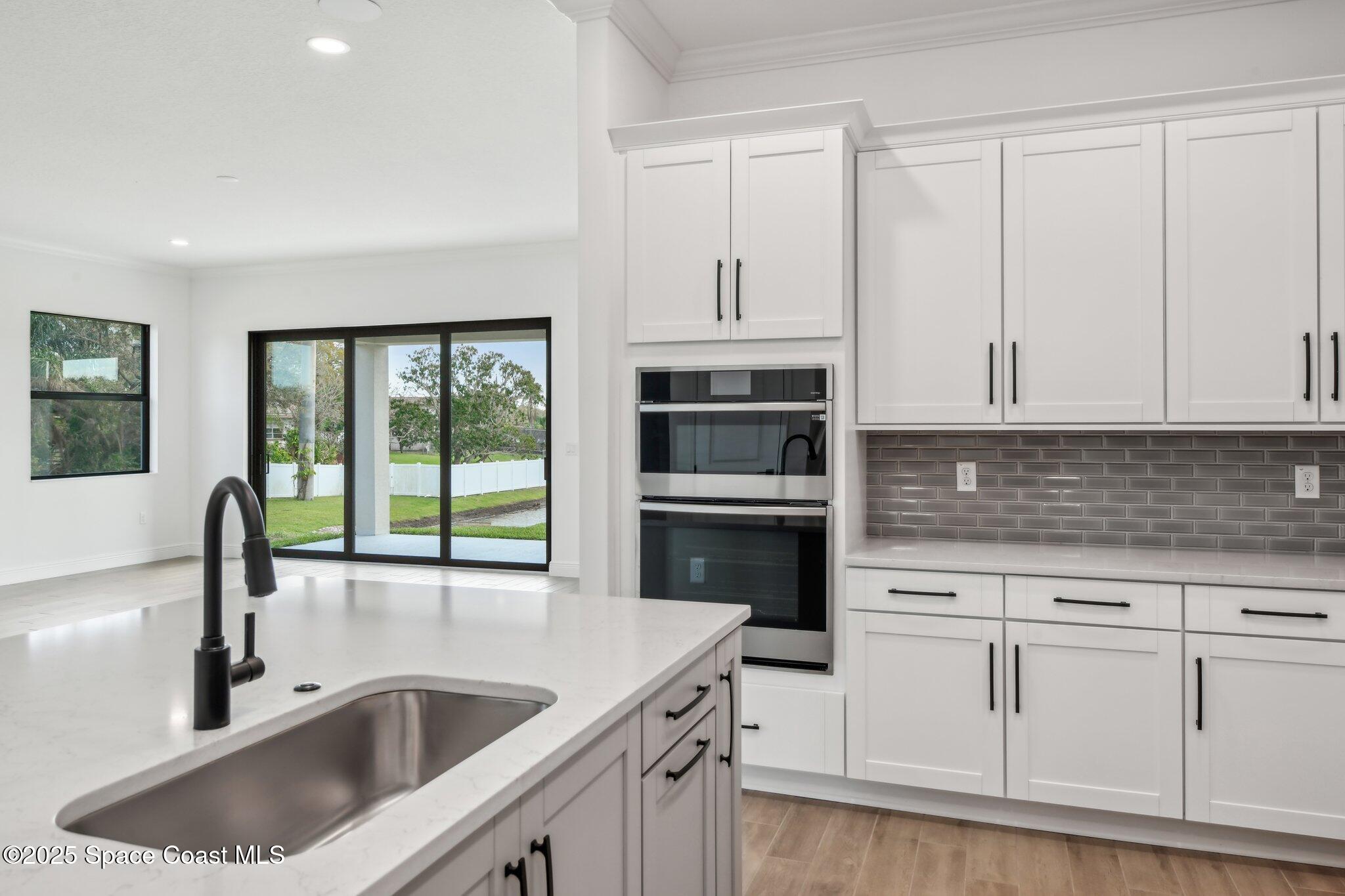 1405 Windchime Lane Melbourne, FL 32935 - Photo 17 of 48 a kitchen with granite countertop a sink and cabinets