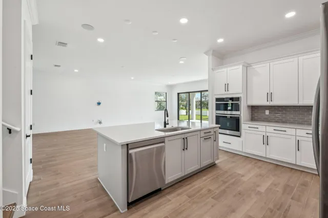 a kitchen with a sink stove and cabinets
