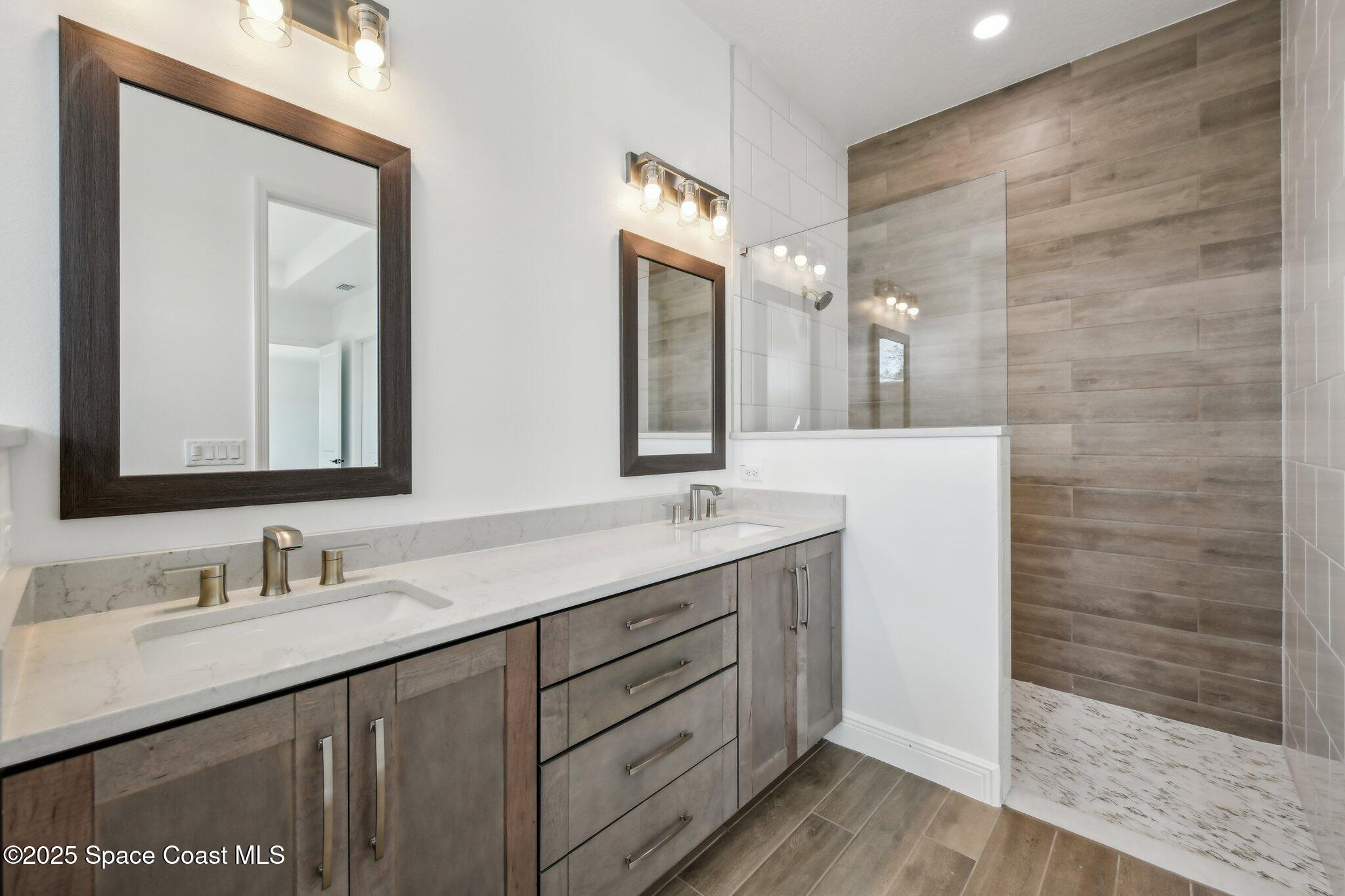 1405 Windchime Lane Melbourne, FL 32935 - Photo 24 of 48 a bathroom with a double vanity sink and a mirror