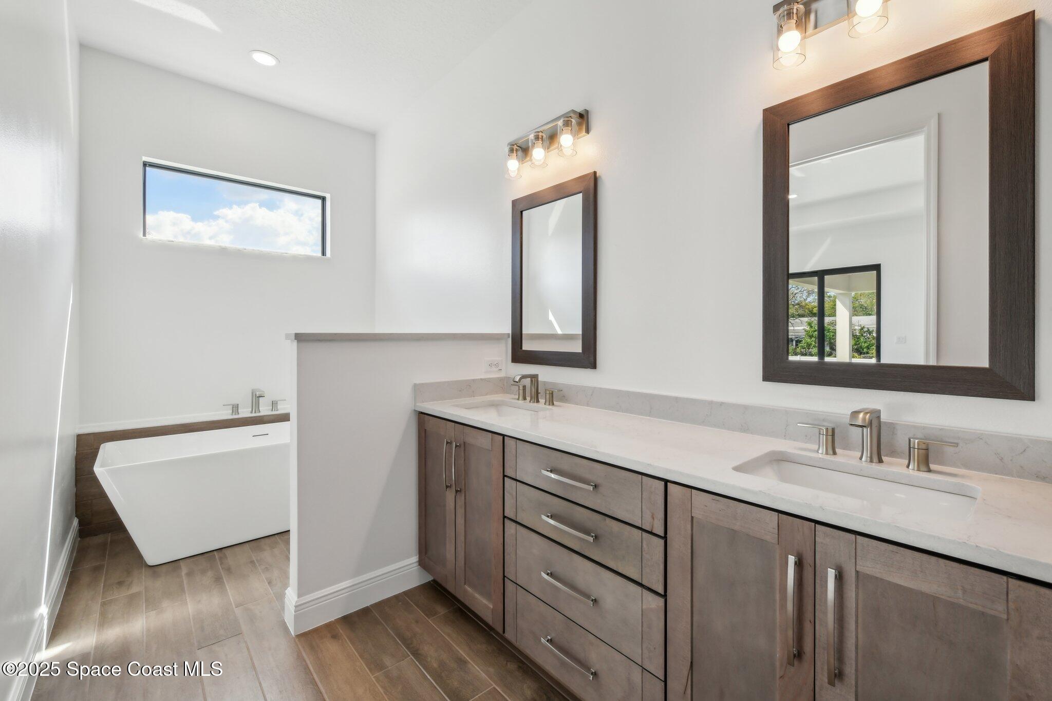 1405 Windchime Lane Melbourne, FL 32935 - Photo 25 of 48 a bathroom with a double vanity sink mirror and