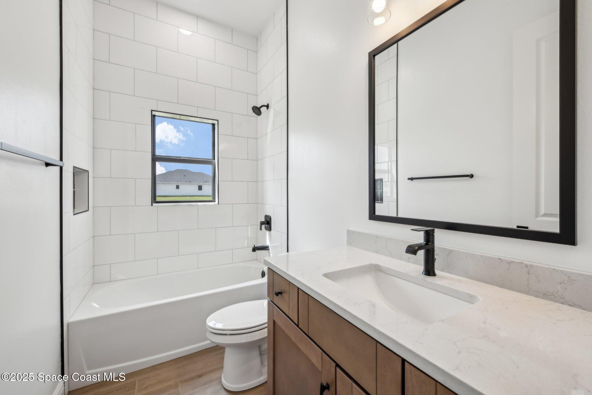 1405 Windchime Lane Melbourne, FL 32935 - Photo 28 of 48 a bathroom with a sink a toilet and shower