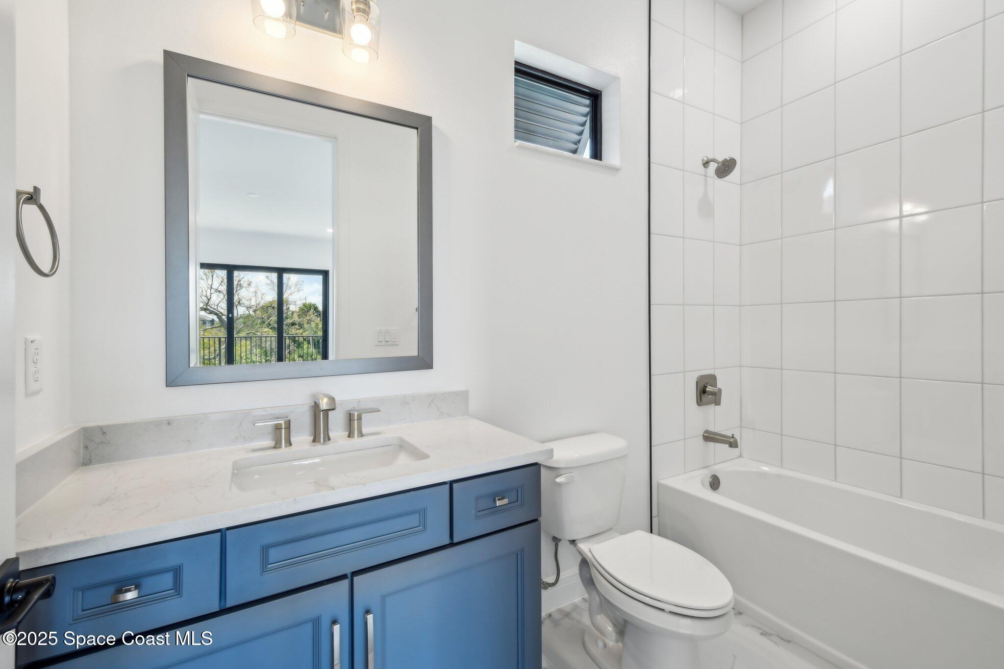 1405 Windchime Lane Melbourne, FL 32935 - Photo 33 of 48 a bathroom with a sink a toilet and shower