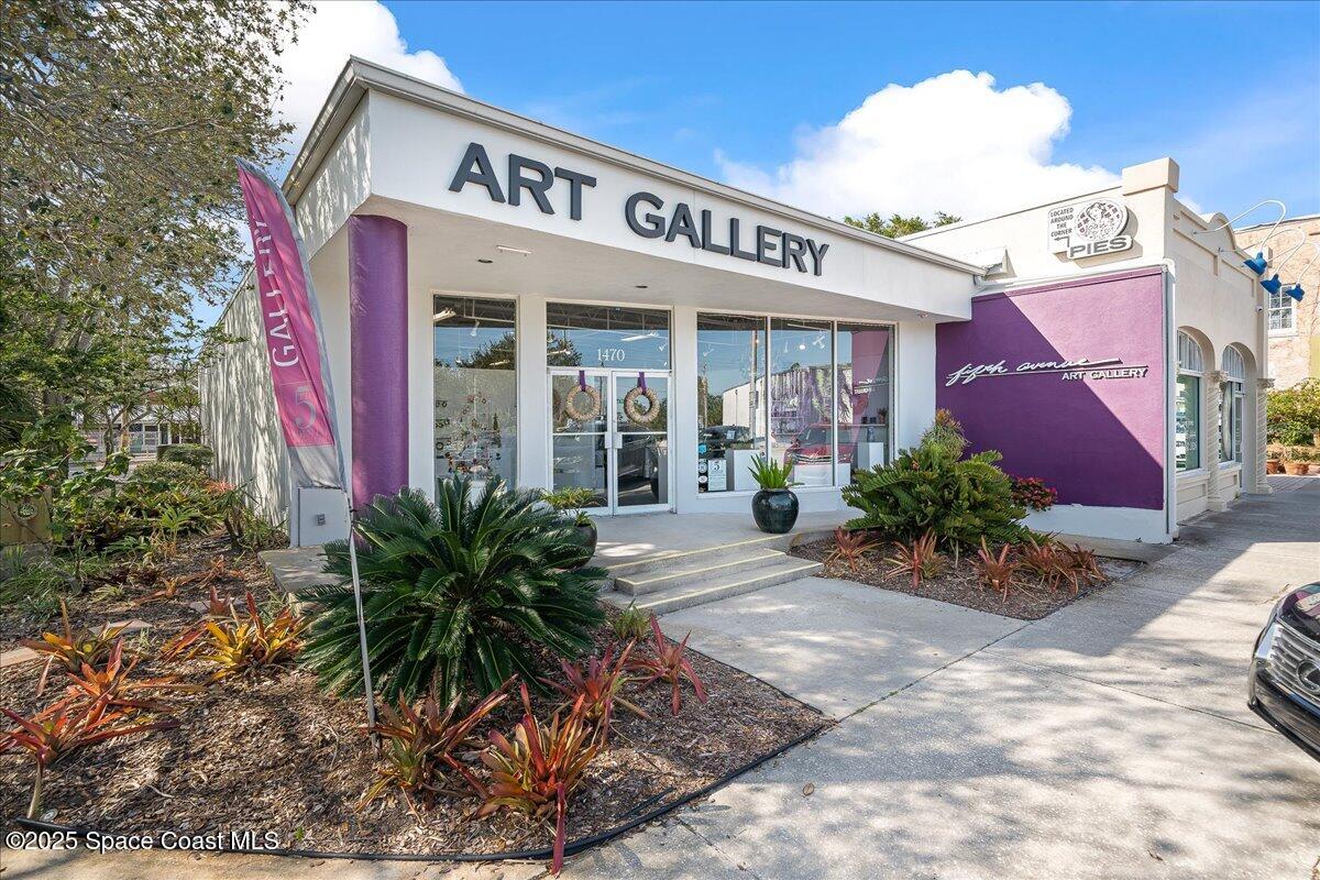 1405 Windchime Lane Melbourne, FL 32935 - Photo 39 of 48 a view of a house with potted plants next to a road