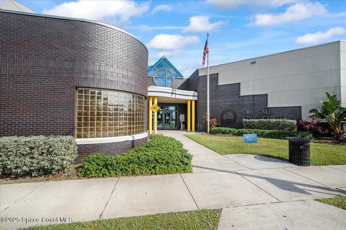 1405 Windchime Lane Melbourne, FL 32935 - Photo 40 of 48 a front view of a house with a yard and potted plants