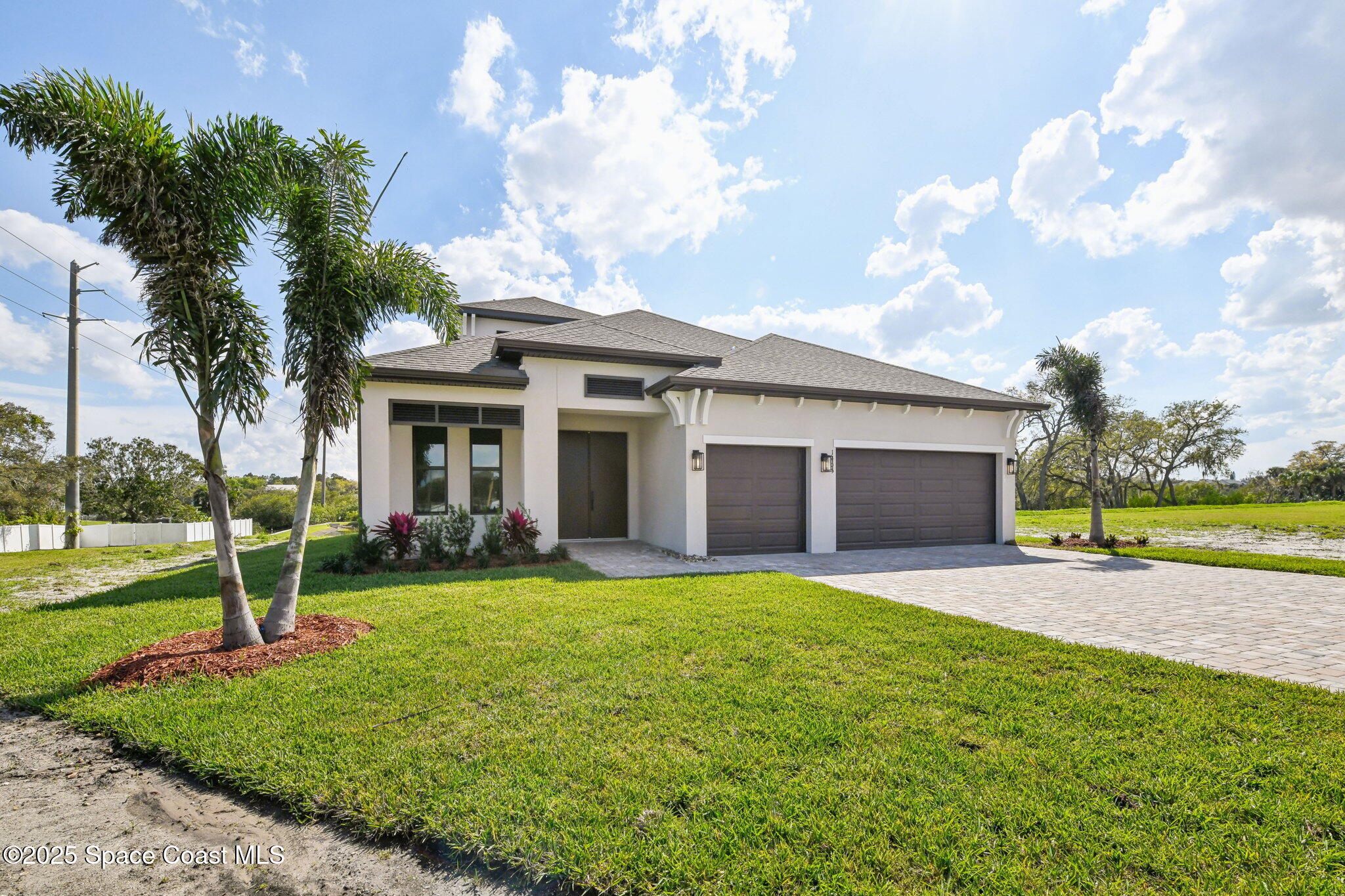1405 Windchime Lane Melbourne, FL 32935 - Photo 4 of 48 a view of a house with a yard and palm tree