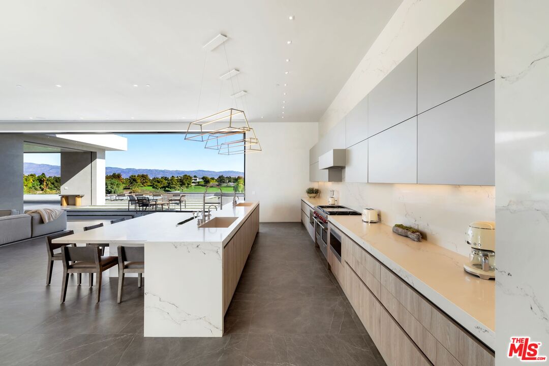 53804 Ross Avenue La Quinta, CA 92253 - Photo 13 of 29 a kitchen with a sink stove and cabinets