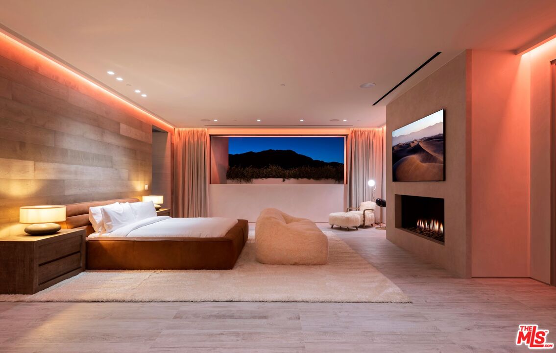 53804 Ross Avenue La Quinta, CA 92253 - Photo 26 of 29 a bedroom with a bed and a fireplace