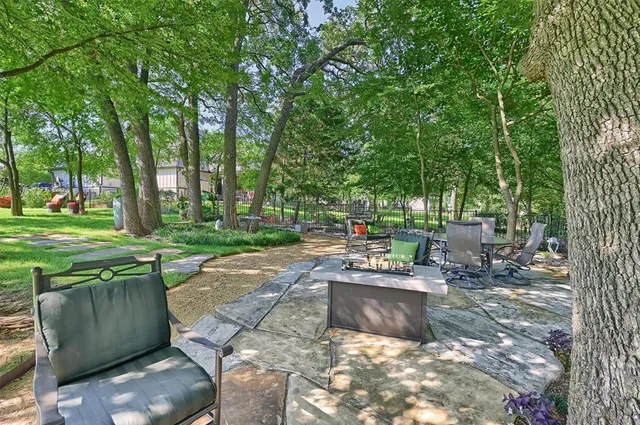a view of a patio with chairs and a small yard