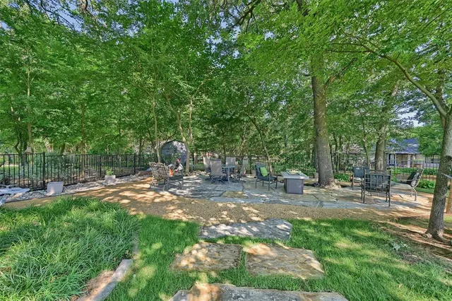 a backyard of a house with table and chairs