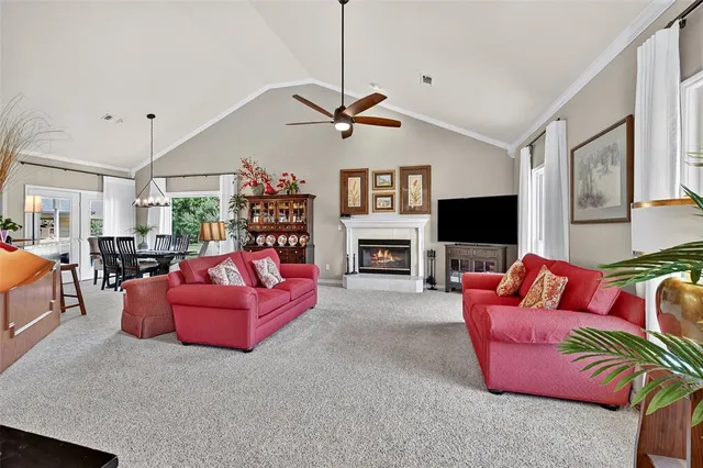 a living room with fireplace furniture and a flat screen tv