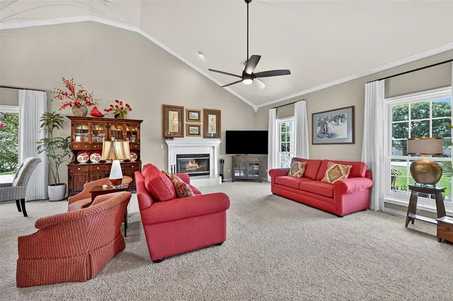 a living room with fireplace furniture and a flat screen tv