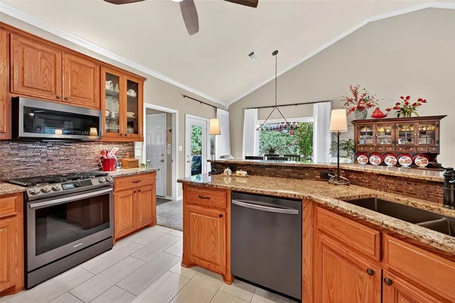 a kitchen with stainless steel appliances granite countertop a stove and a sink