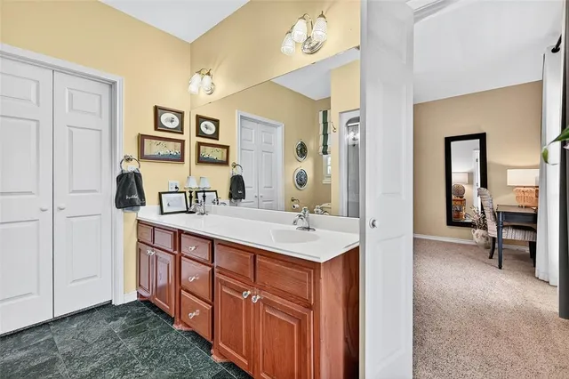 a bathroom with a sink a mirror and a vanity