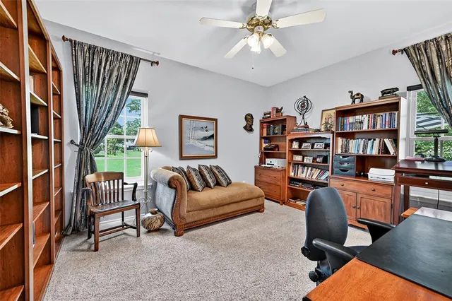 a living room with furniture and a book shelf