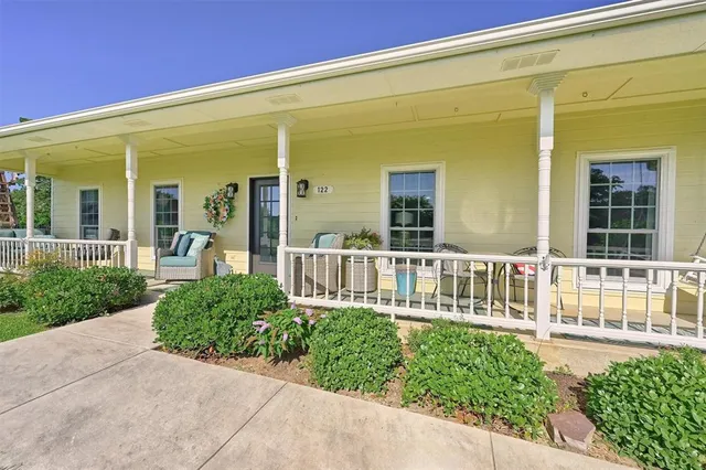 a view of a house with a small yard and plants