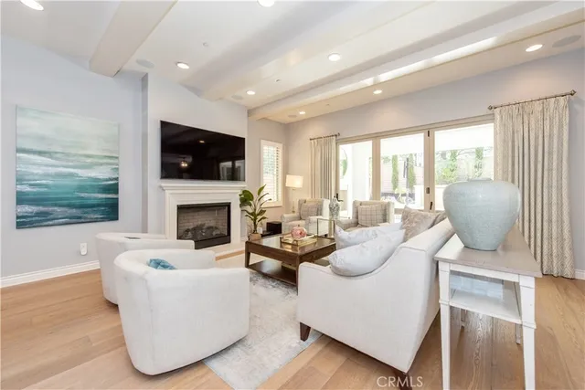 a dining room with wooden floor a chandelier a wooden table and chairs