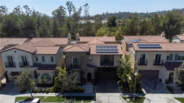 an aerial view of residential houses with outdoor space and parking
