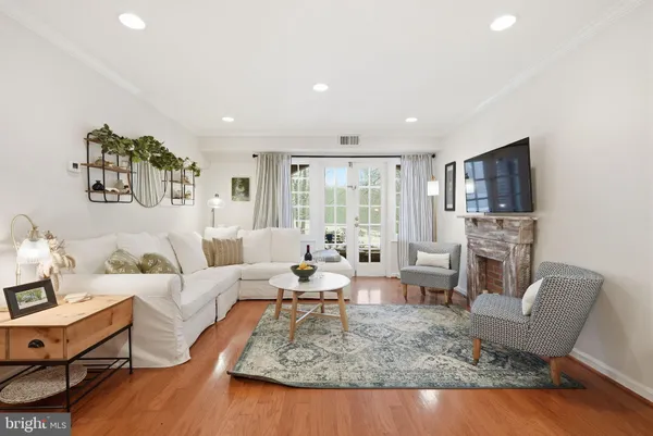 a living room with fireplace furniture and a flat screen tv
