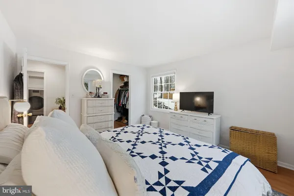 a living room with furniture and a book shelf