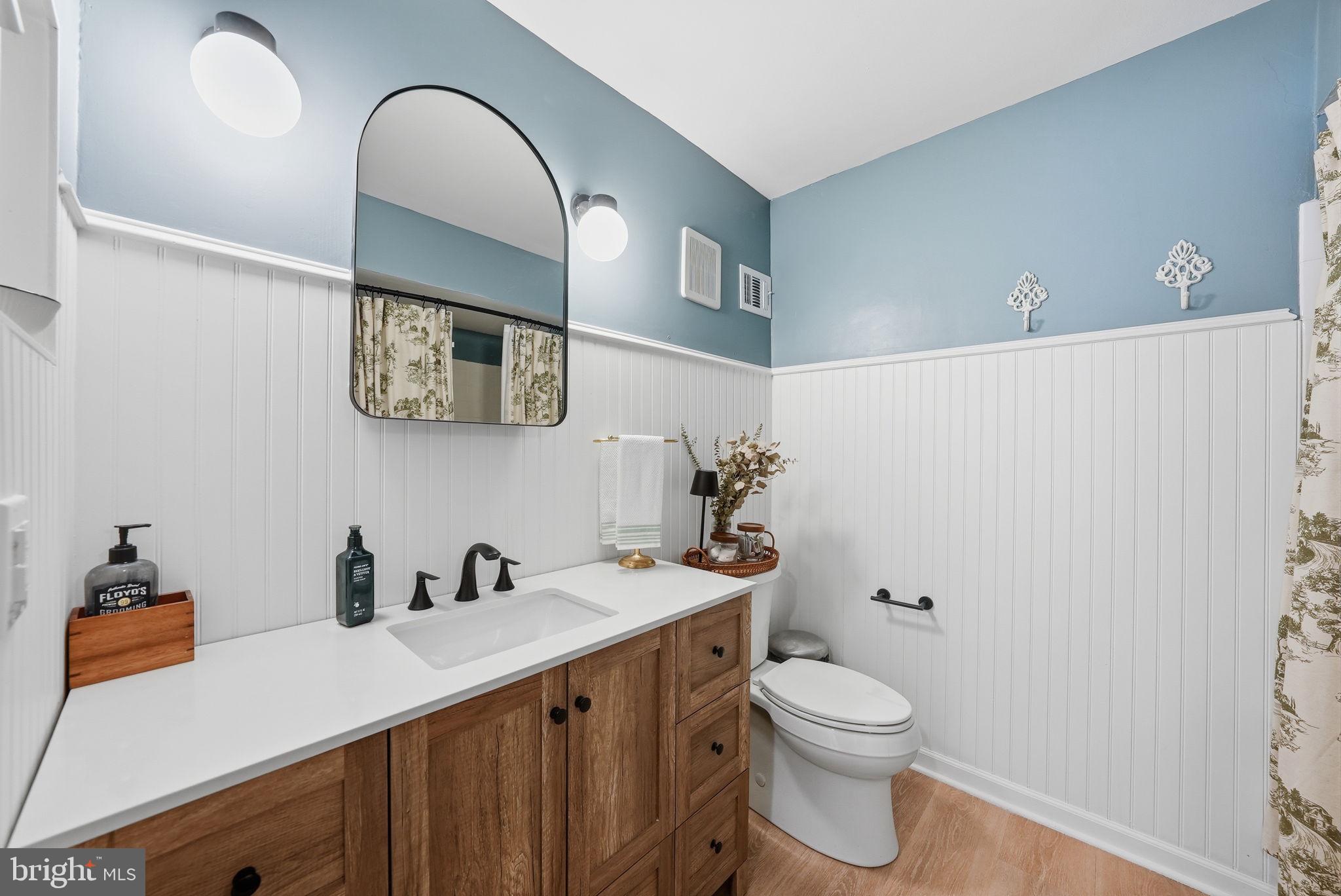 8231 Kings Charter Lane, Unit 108 Springfield, VA 22152 - Photo 20 of 37 a bathroom with a toilet a sink and mirror