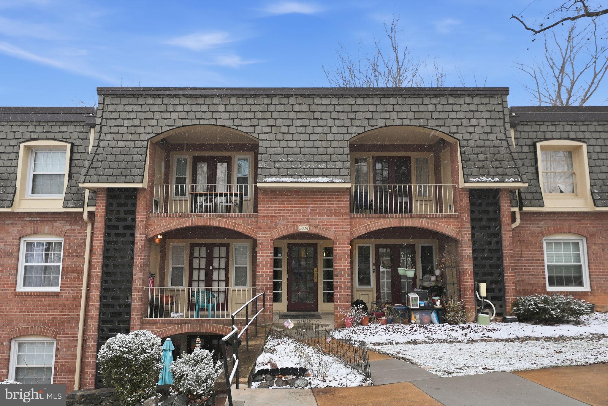 8231 Kings Charter Lane, Unit 108 Springfield, VA 22152 - Photo 2 of 37 a front view of a building with many windows