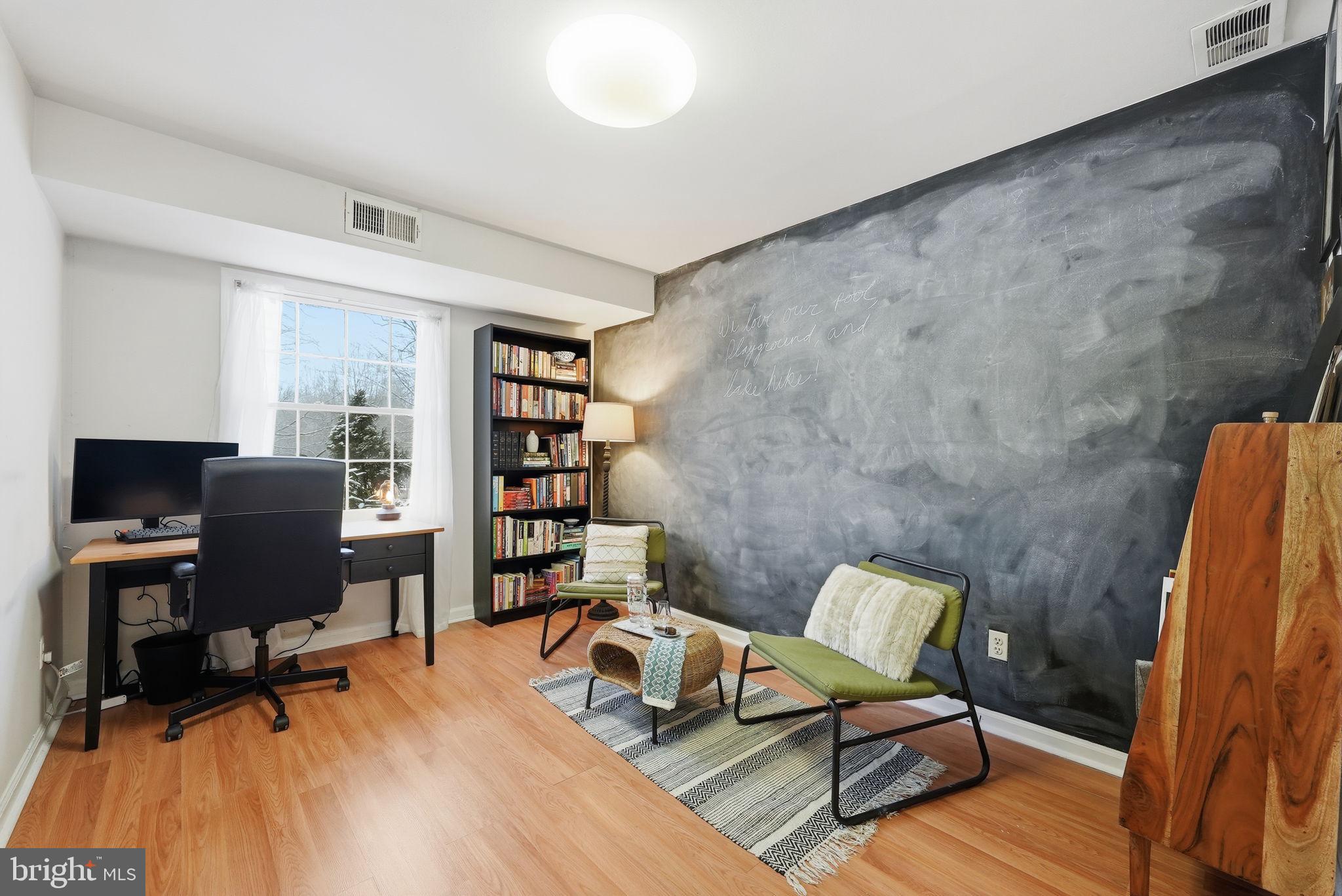 8231 Kings Charter Lane, Unit 108 Springfield, VA 22152 - Photo 24 of 37 a living room with furniture and a wooden floor