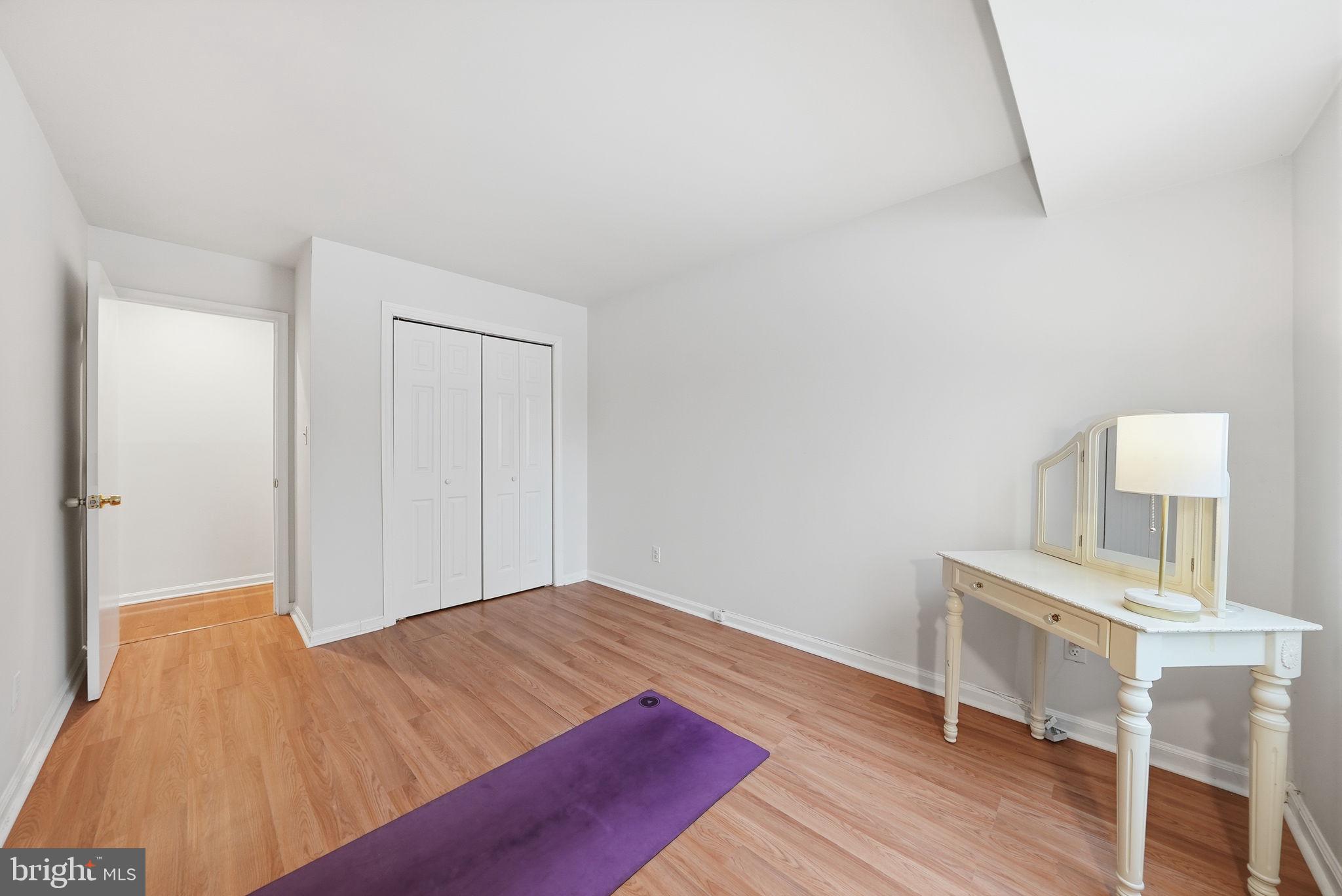 8231 Kings Charter Lane, Unit 108 Springfield, VA 22152 - Photo 27 of 37 a bedroom with a bed and a table in it