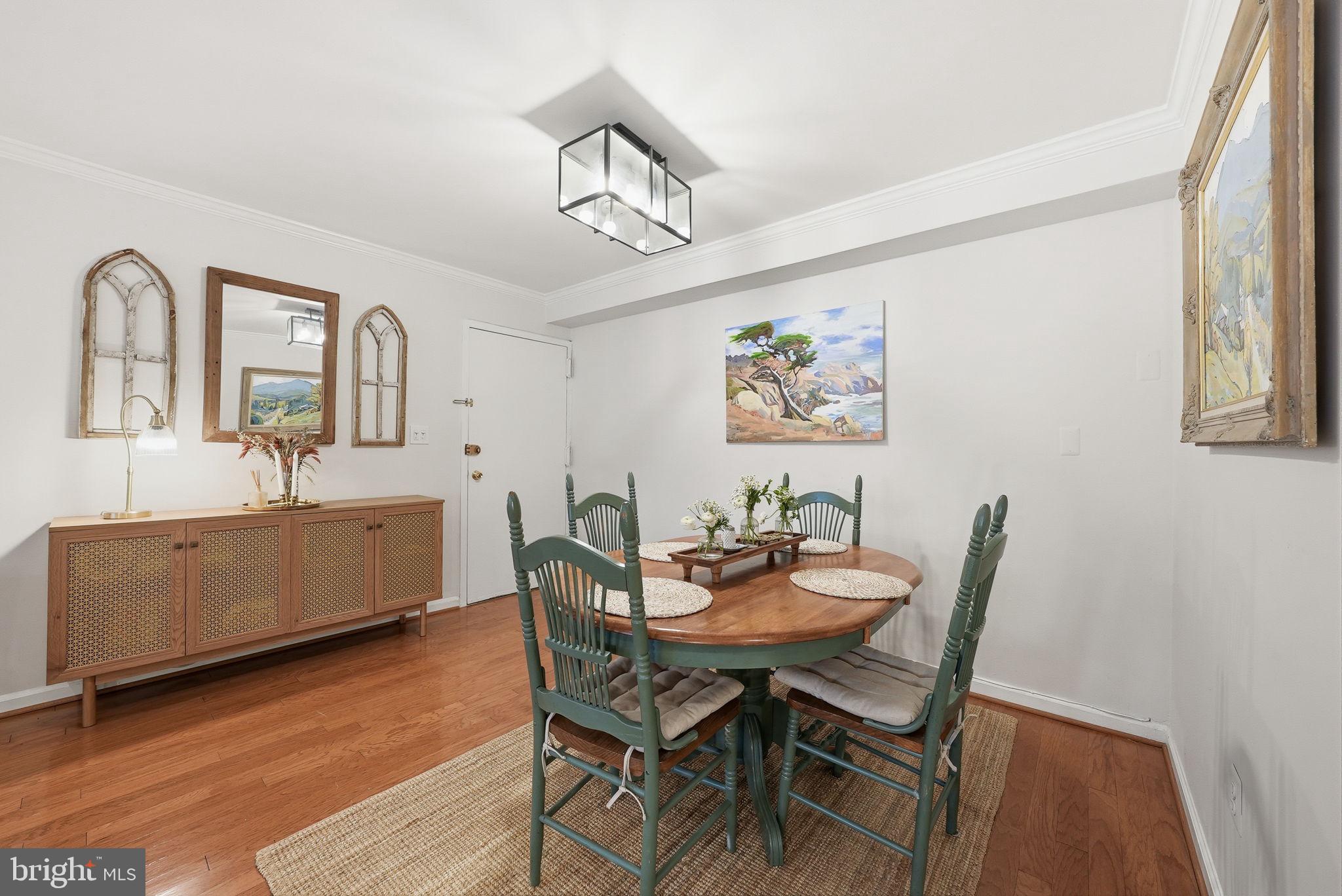 8231 Kings Charter Lane, Unit 108 Springfield, VA 22152 - Photo 7 of 37 a dining room with furniture a window and wooden floor