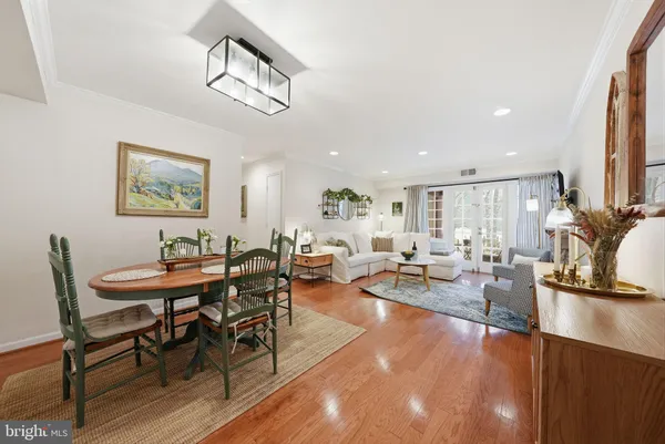 a dining room with furniture and wooden floor