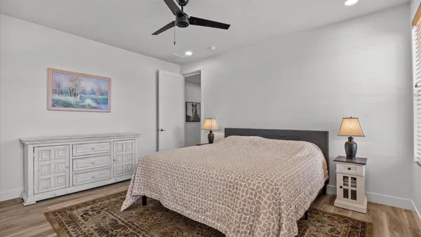 a bedroom with a large bed and a chandelier