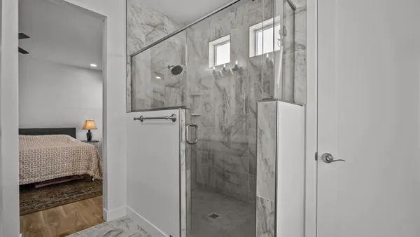 a bathroom with a shower and a sink