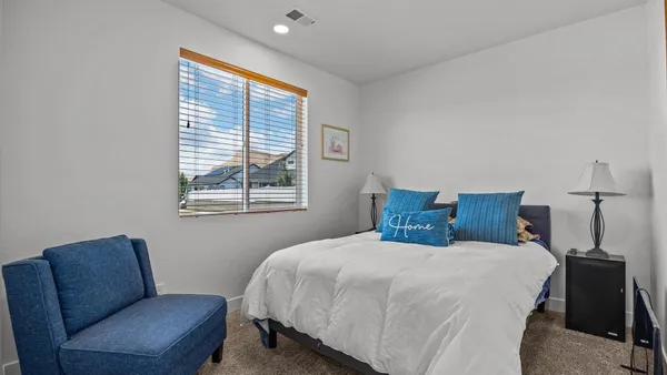 a bedroom with a bed couch and window