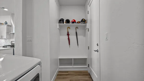 a view of an entryway with wooden floor