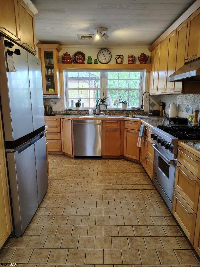 442 River Road North Arlington, NJ 07031 - Photo 10 of 26 a large kitchen with stainless steel appliances granite countertop a stove a sink dishwasher and refrigerator with wooden floor