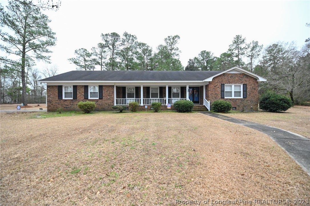 811 Butler Island Road Roseboro, NC 28382 - Photo 1 of 43 a front view of a house with a yard and trees