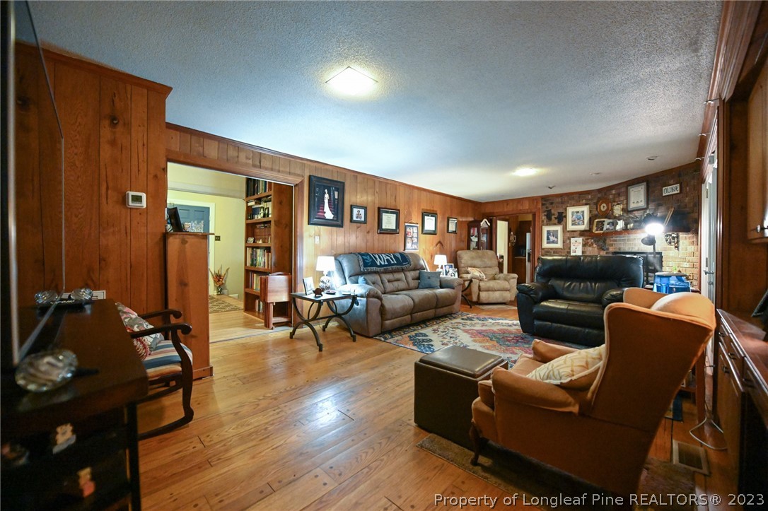 811 Butler Island Road Roseboro, NC 28382 - Photo 12 of 43 a living room with furniture and a wooden floor