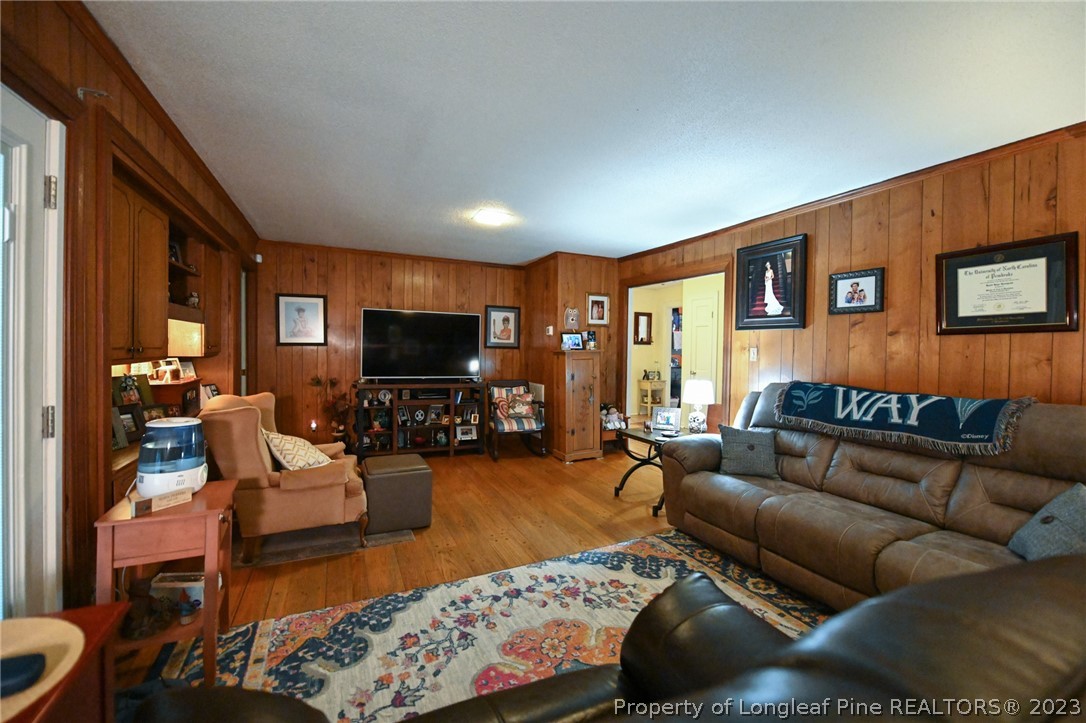 811 Butler Island Road Roseboro, NC 28382 - Photo 14 of 43 a living room with furniture and a flat screen tv