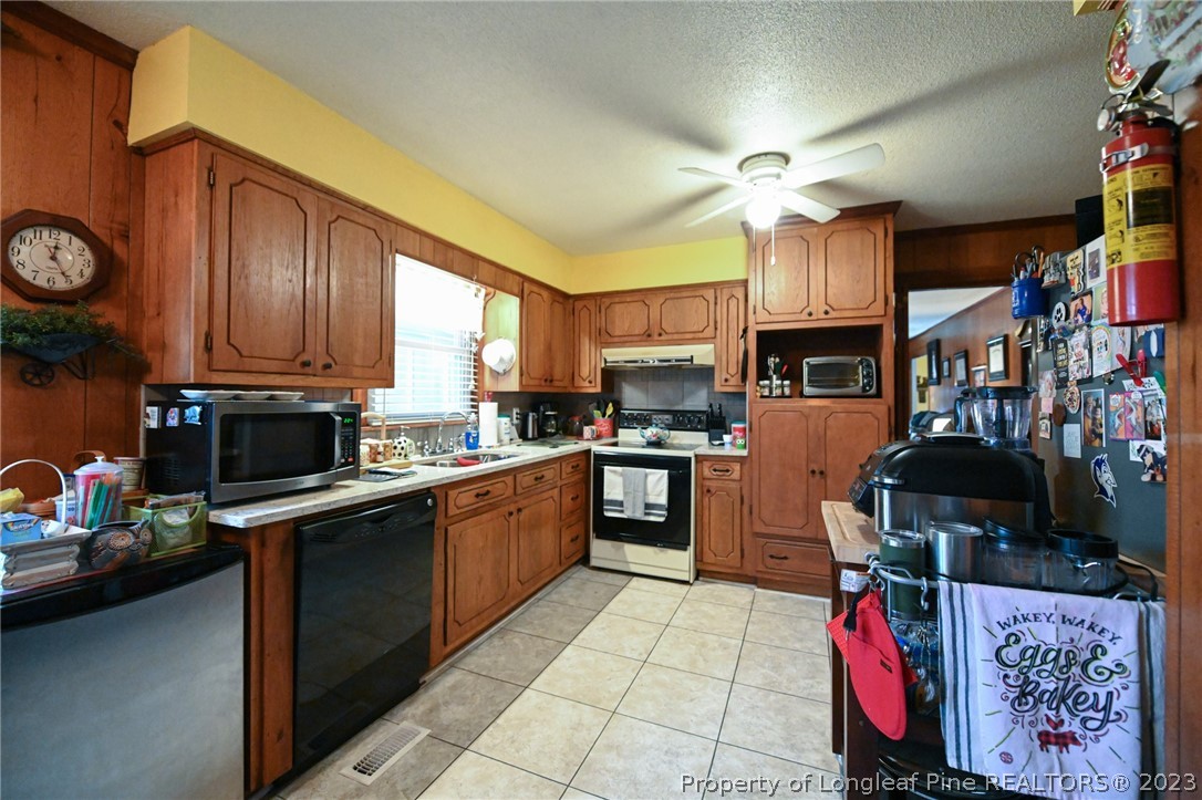 811 Butler Island Road Roseboro, NC 28382 - Photo 15 of 43 a kitchen with cabinets and window