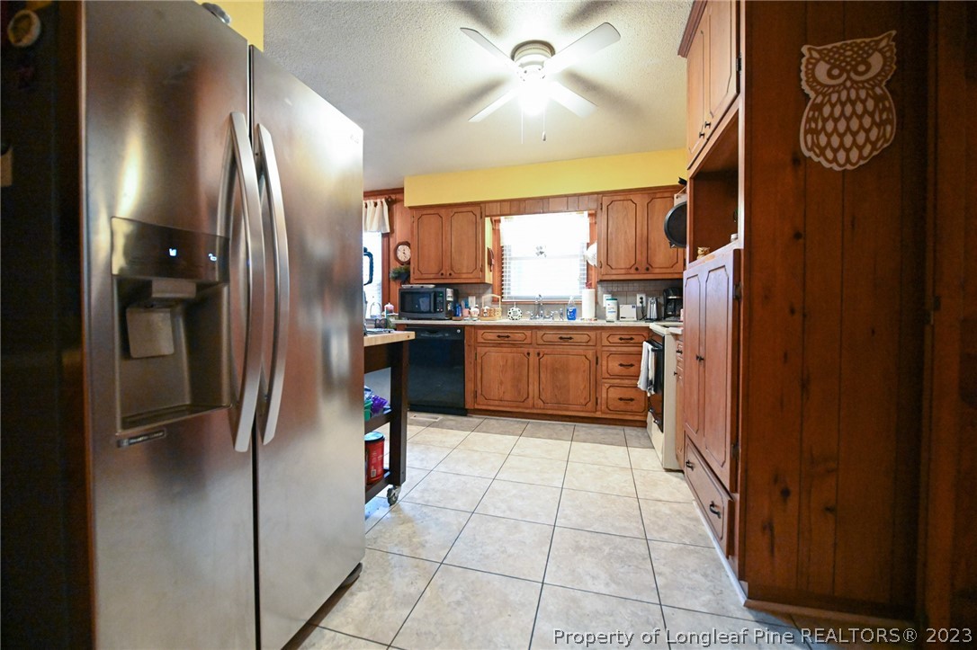 811 Butler Island Road Roseboro, NC 28382 - Photo 17 of 43 a kitchen with stainless steel appliances granite countertop a refrigerator and a sink
