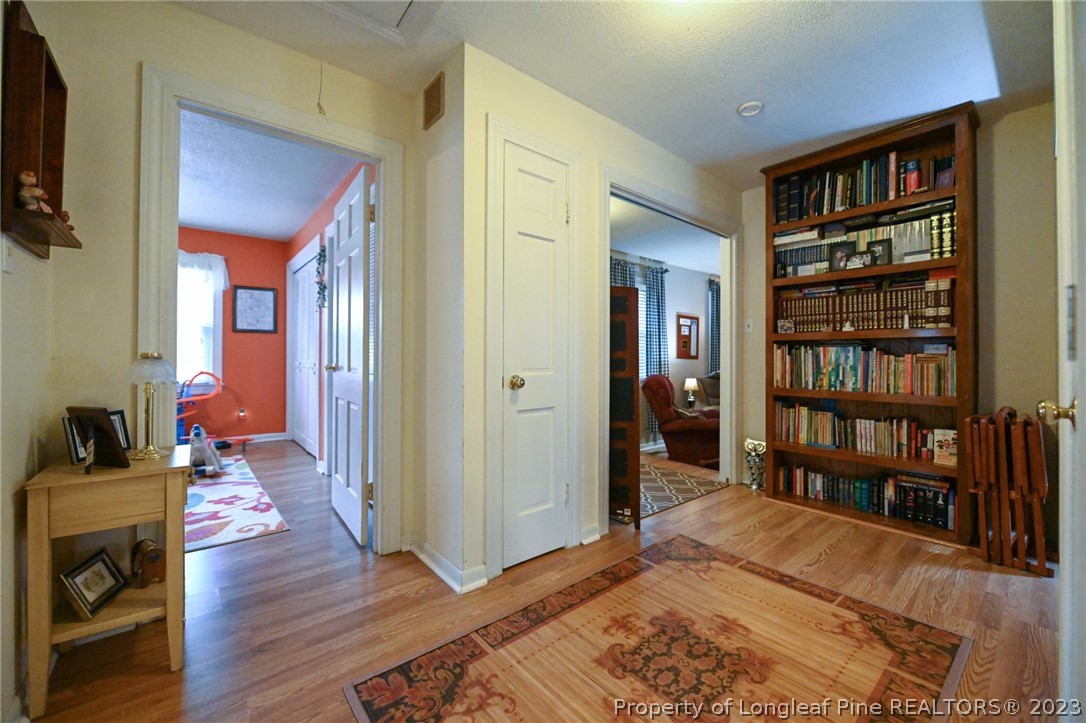 811 Butler Island Road Roseboro, NC 28382 - Photo 23 of 43 a bedroom with furniture and a book shelf
