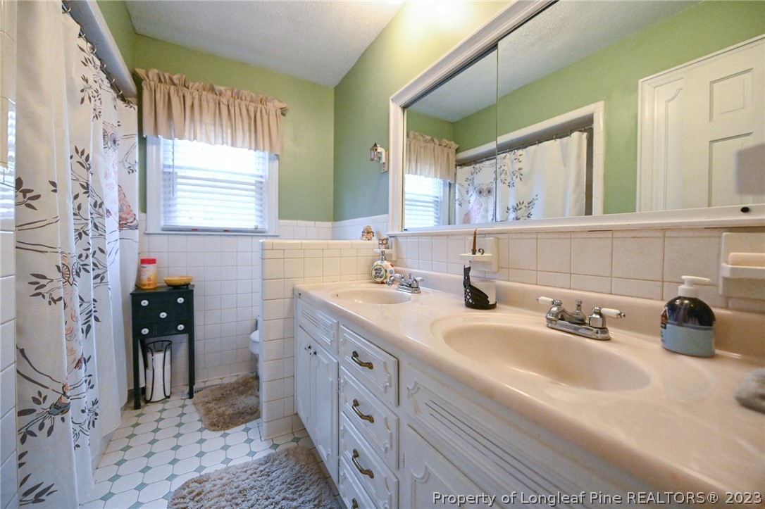 811 Butler Island Road Roseboro, NC 28382 - Photo 32 of 43 a bathroom with a double vanity sink mirror and