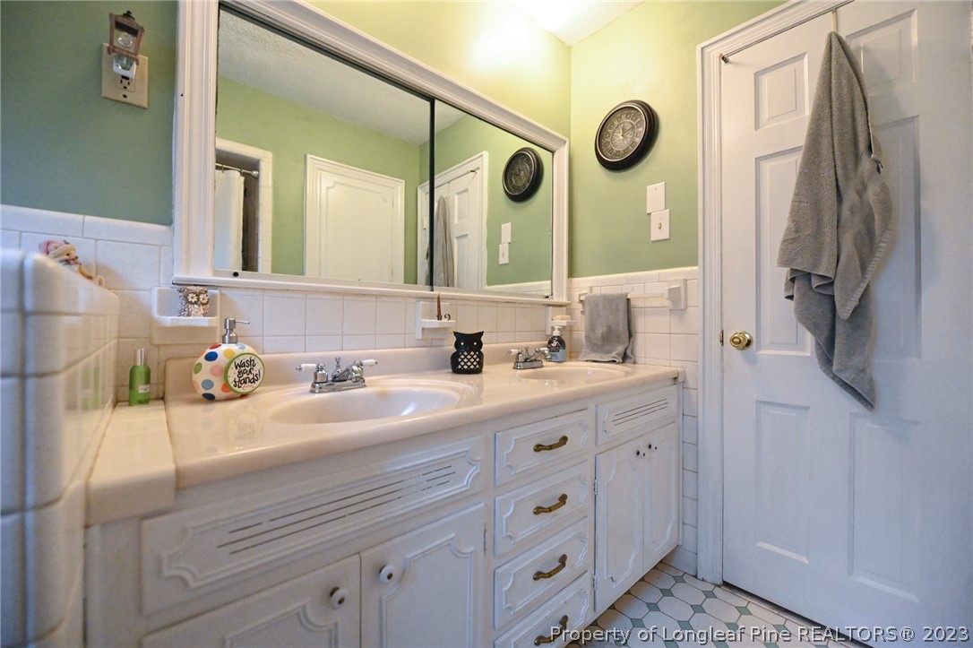 811 Butler Island Road Roseboro, NC 28382 - Photo 33 of 43 a bathroom with a double vanity sink mirror and shower