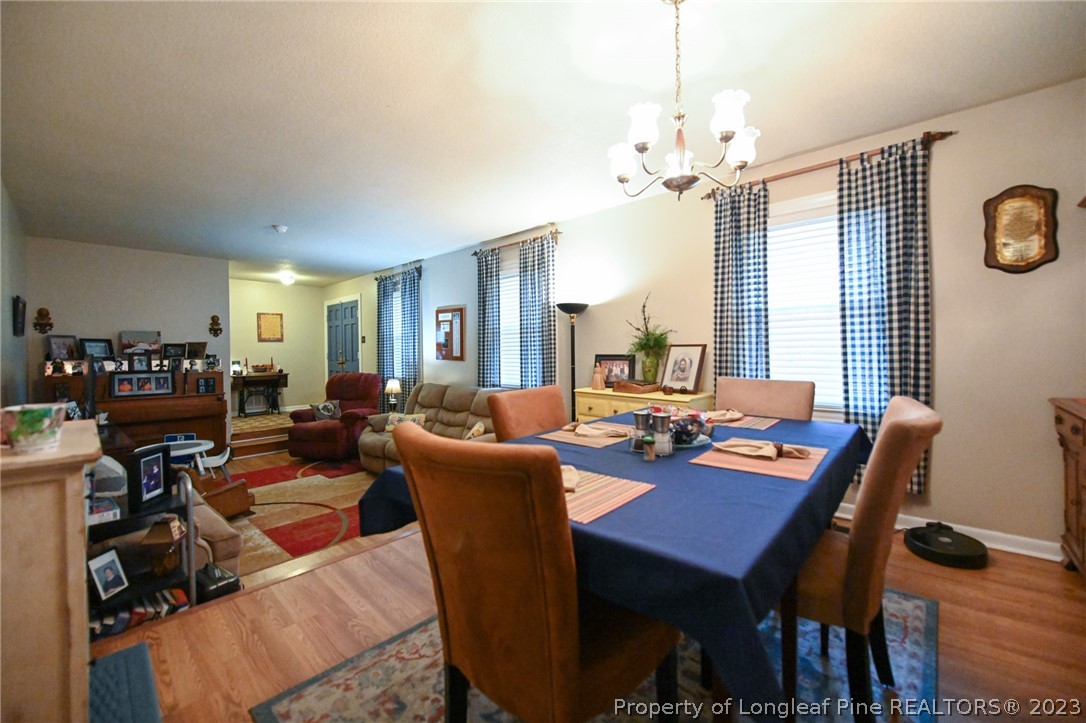 811 Butler Island Road Roseboro, NC 28382 - Photo 10 of 43 a view of a dining room with furniture window and wooden floor