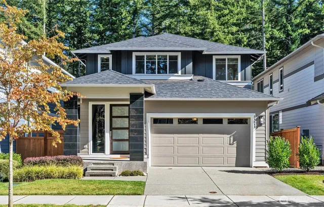 a front view of a house with a garden