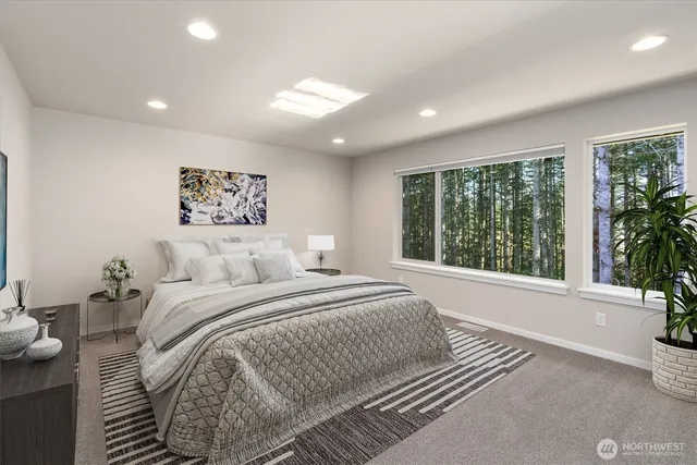 a spacious bedroom with a large bed and a large window