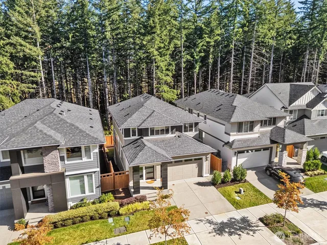an aerial view of a residential houses with yard