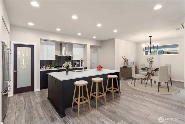 a large kitchen with a table and chairs